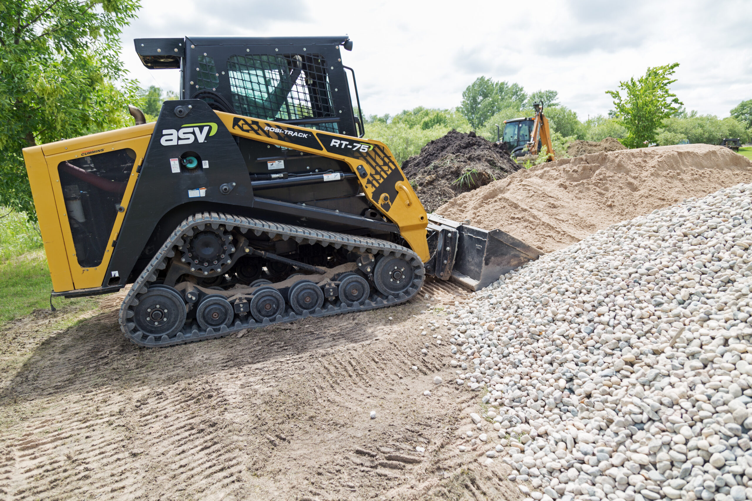 compact track loader moving gravel