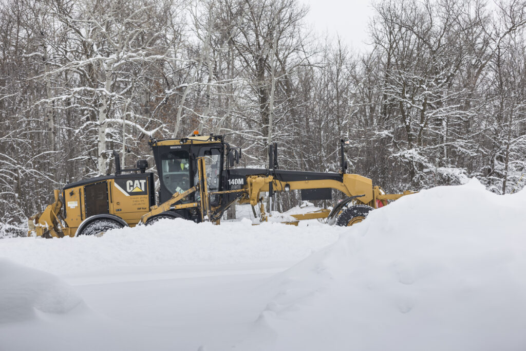 motor grader clearing snow