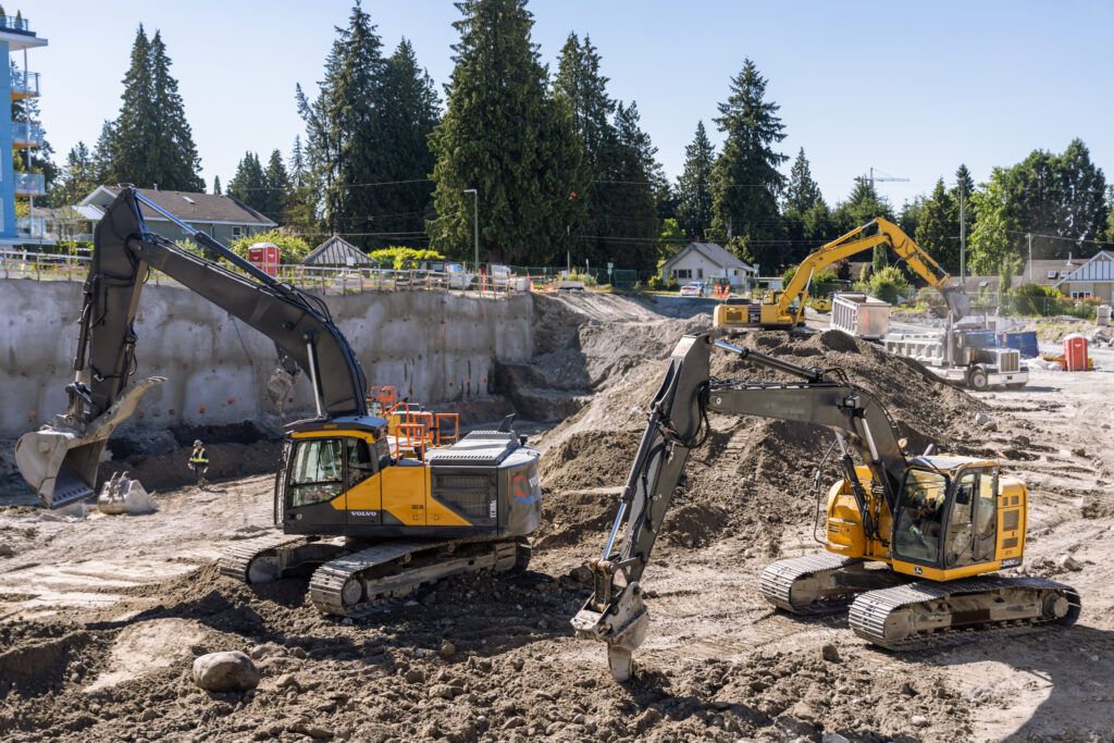 excavators operating at an active urban construction job site